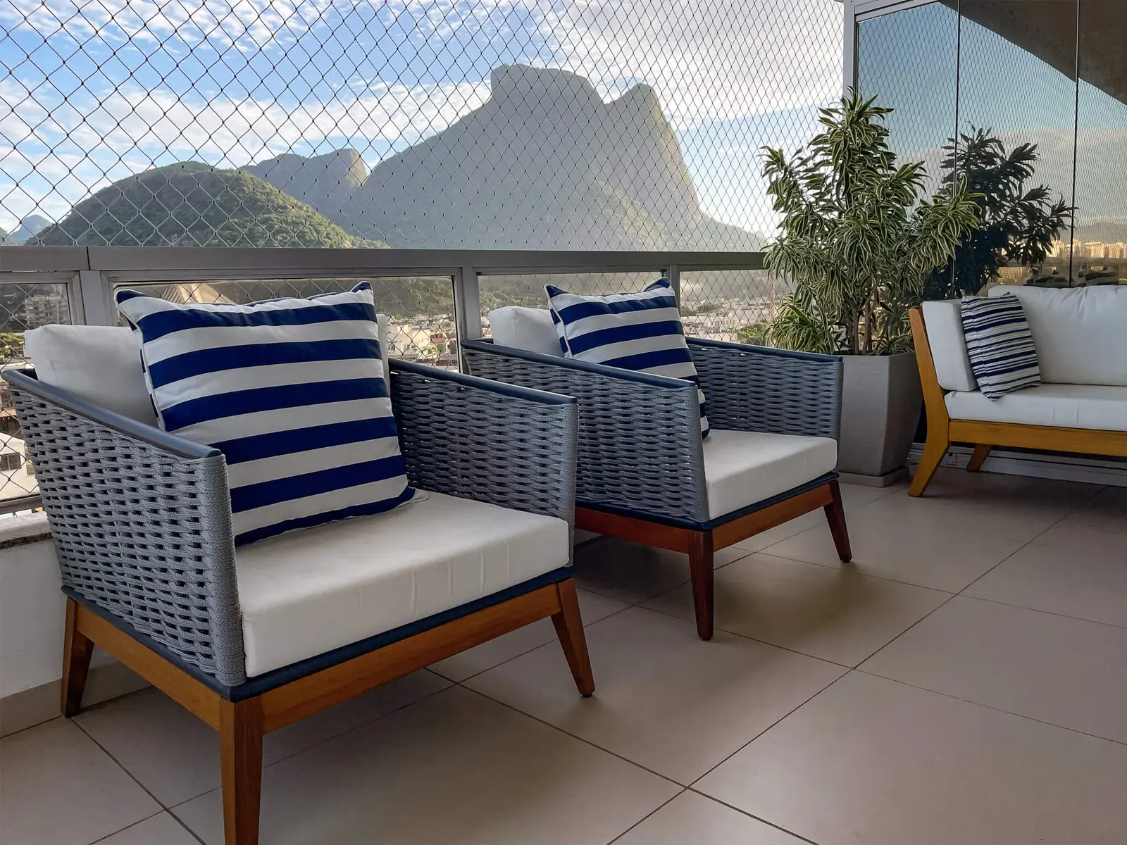 Apartment's balcony lounge chairs with background of a mountain view