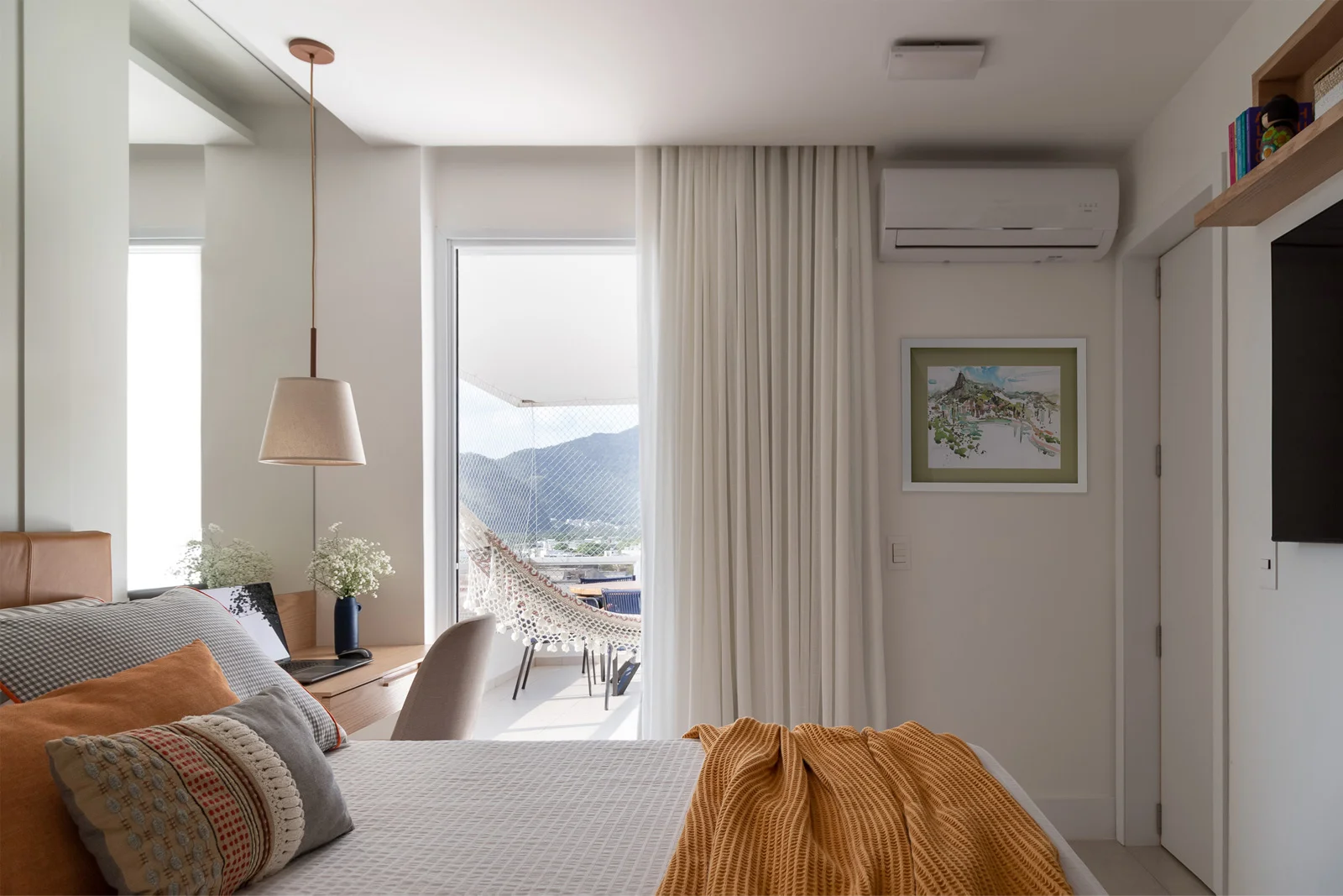 Side view of the bedroom showing the view to the balcony with mountains on the background